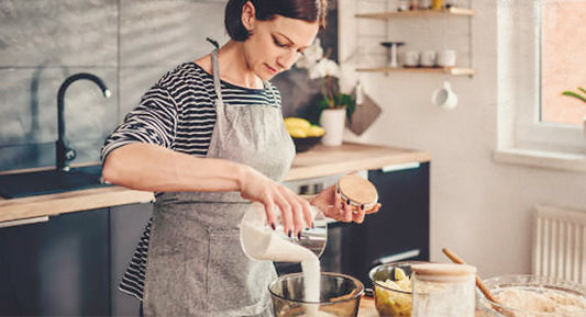 A woman baking with sugar.