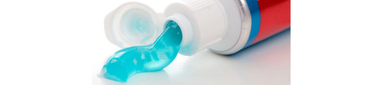 Close up of blue gel toothpaste being squeezed out of tube, for AutoBrush blog