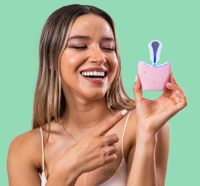 Woman with autobrush automatic tongue scraper that doesn't cause gagging