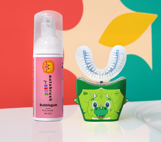Automated toothbrush and bottle of toothpaste with colorful abstract background. #sonicprokidsbundle