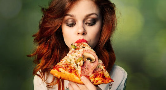 Eating a slice of pizza.
