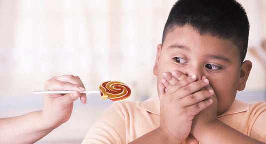 Child rejecting a lollipop.