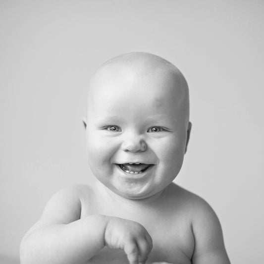 Smiling baby showing off his/her baby teeth, for AutoBrush