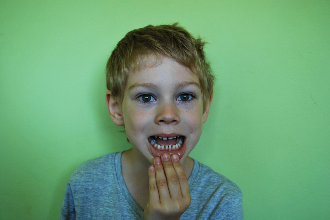 Boy on green background showing his teeth, for AutoBrush