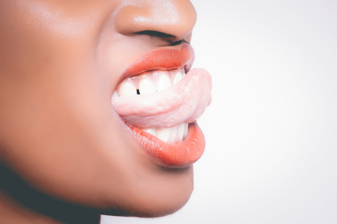 Woman showing her teeth and tongue with red lipstick, for AutoBrush