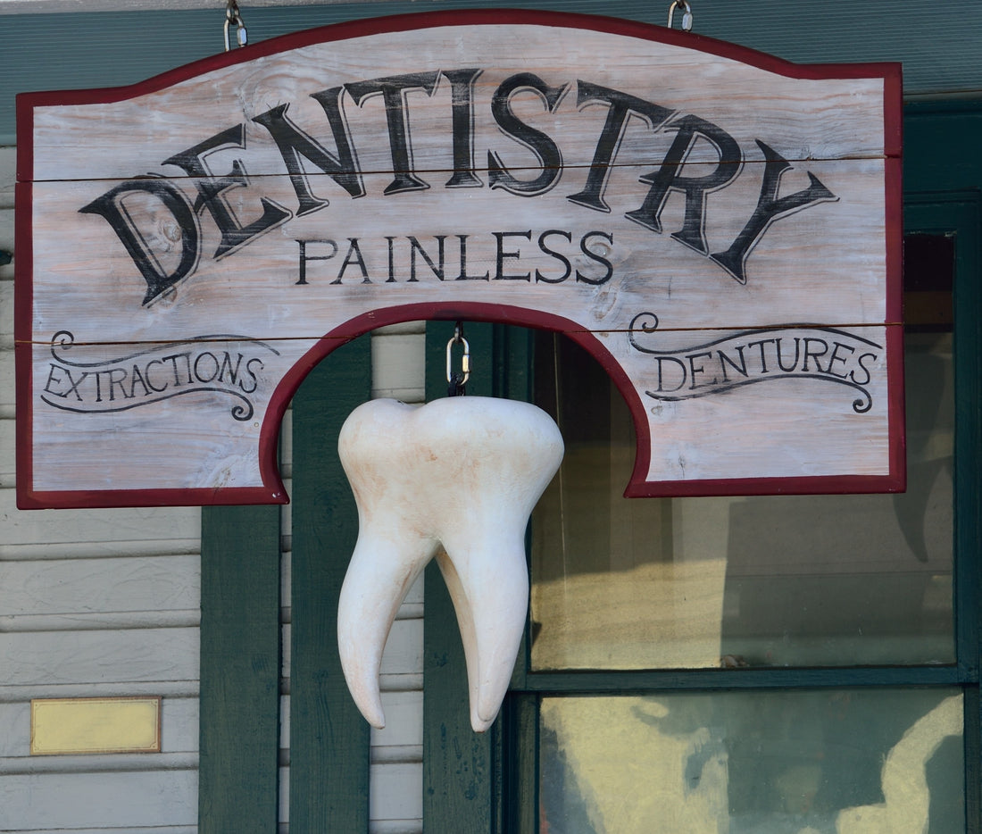 Dental clinic sign with a giant tooth below it, for Autobrush