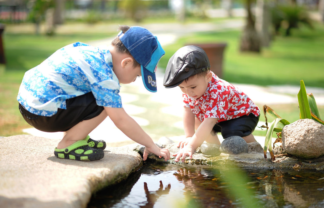 Two kids wearing hats, playing near a pond, for AutoBrush