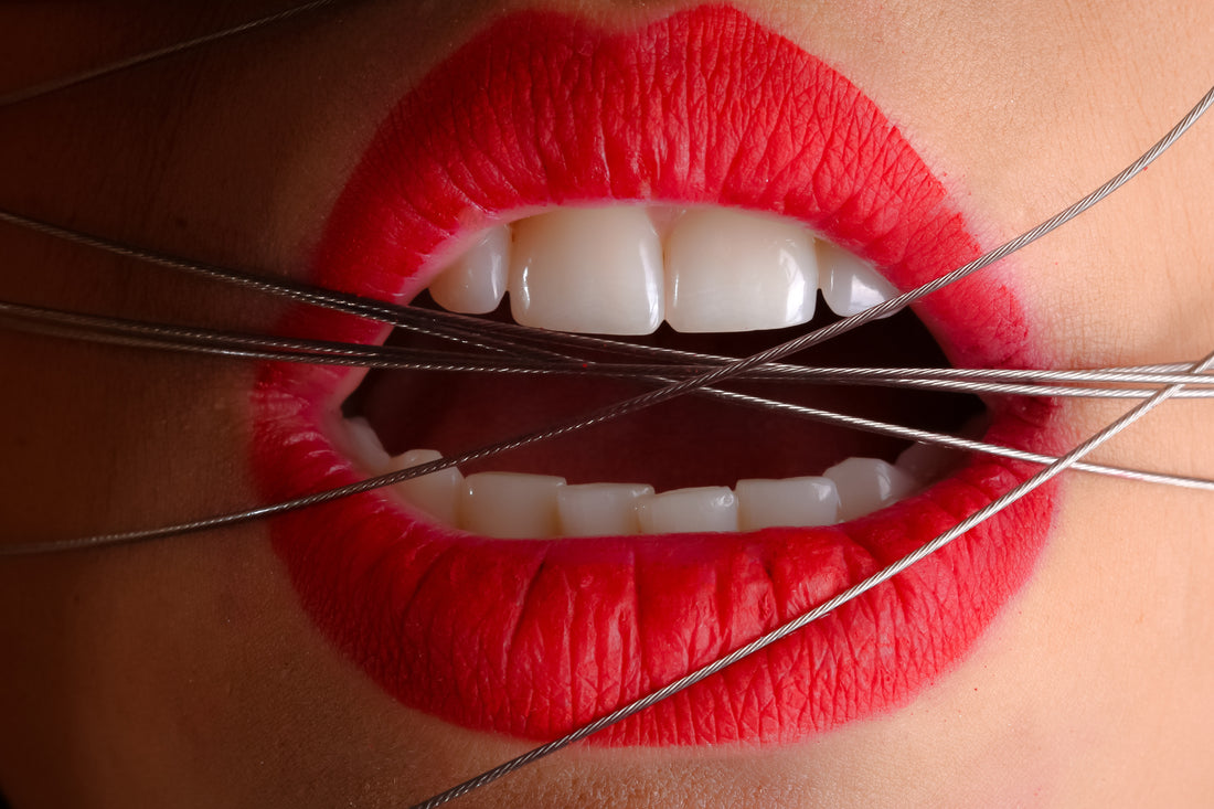 Woman with red lipstick with wires wrapped around her mouth, for AutoBrush