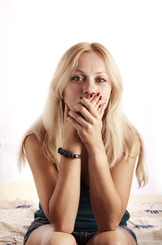Blonde woman with her hands over her mouth, for AutoBrush