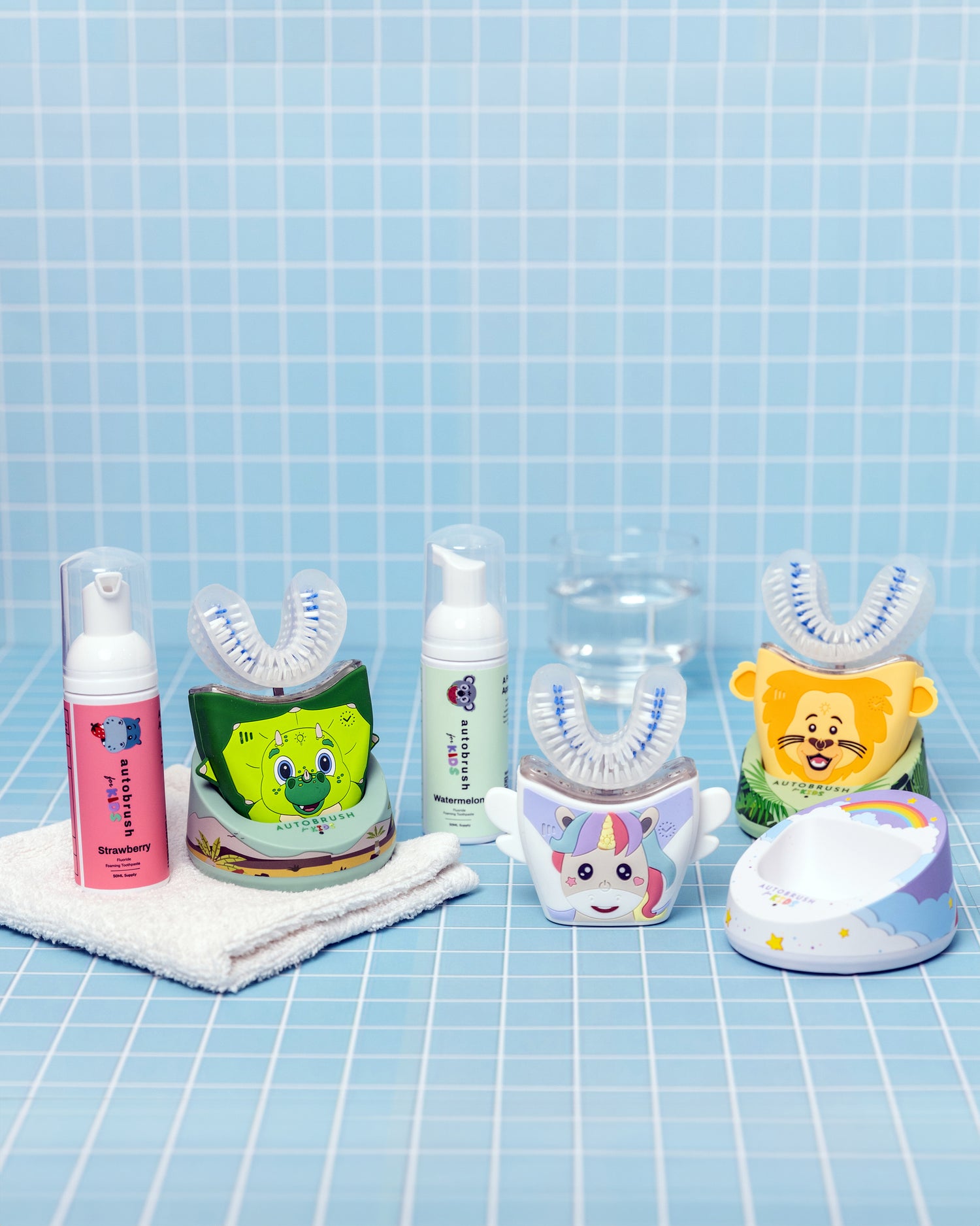 Collection of children's dental care products on a blue grid background