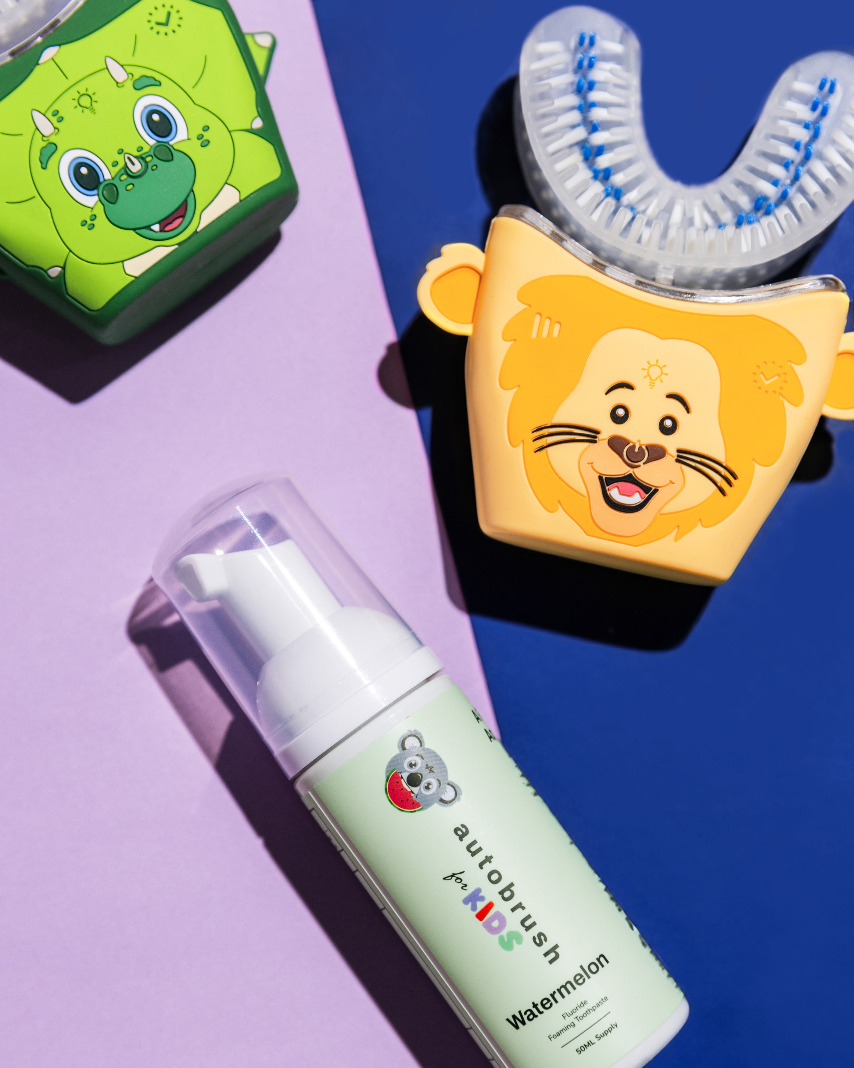 Children's toothbrush with cartoon lion design and watermelon-flavored toothpaste on a colorful background