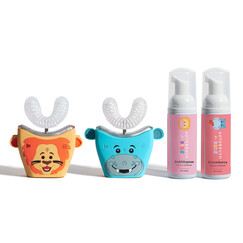 Two animal-themed kids' toothbrushes and two bottles of foaming toothpaste.