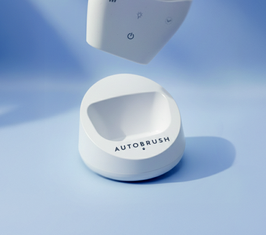 White electronic U-brush charger on a light blue background