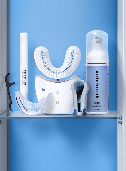 electric U-toothbrush device with cleaning solution and accessories on a blue background