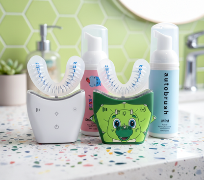 Automated toothbrush and toothpaste on a bathroom counter with a green tiled wall background. #familypack