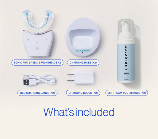 Collection of Autobrush dental care products including base, brush heads, charging base, USB cable, charging block, and mint foam toothpaste on a white background. #partnerpack
